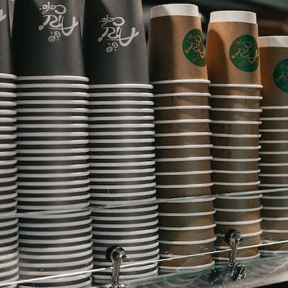 disposable coffee cups stacked unused