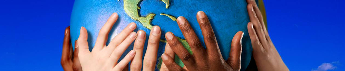 childrens' hands holding up a globe of the earth